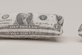 Creative cushion designed to resemble a one-dollar bill, symbolizing the intersection of comfort and capitalism in the Labour Lounge exhibition. fabian-garna-cgi-art-direction