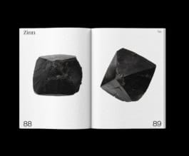 Photograph of two raw tin crystals on a page from the Labour Lounge catalogue, illustrating the natural form of tin used in technology. fabian-garna-cgi-art-direction